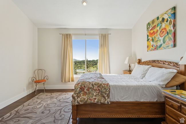 Bedroom featuring wood finished floors and a mountain view | Image 16