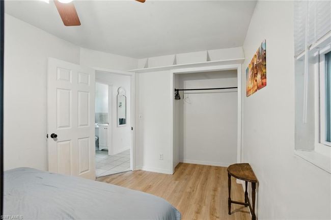 Bedroom featuring light wood-style flooring, a closet, and ceiling fan | Image 27