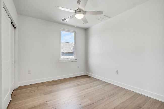 Unfurnished bedroom featuring light wood-style floors, a closet, baseboards, and a ceiling fan | Image 24