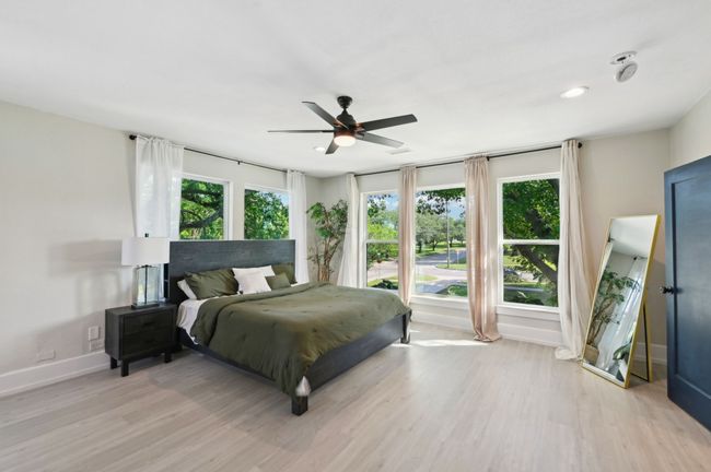 Bedroom with light wood-type flooring, baseboards, a ceiling fan, and recessed lighting | Image 24