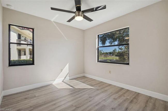 Spare room with light wood-type flooring and ceiling fan | Image 6