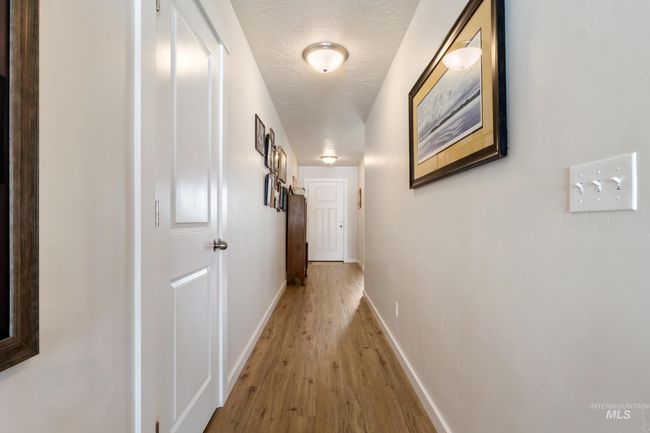 Hallway with light wood finished floors and baseboards | Image 18
