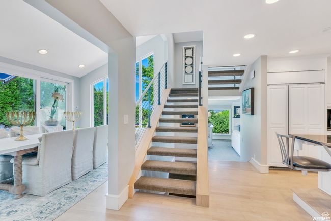 Stairs with a wealth of natural light, recessed lighting, and wood floors | Image 26