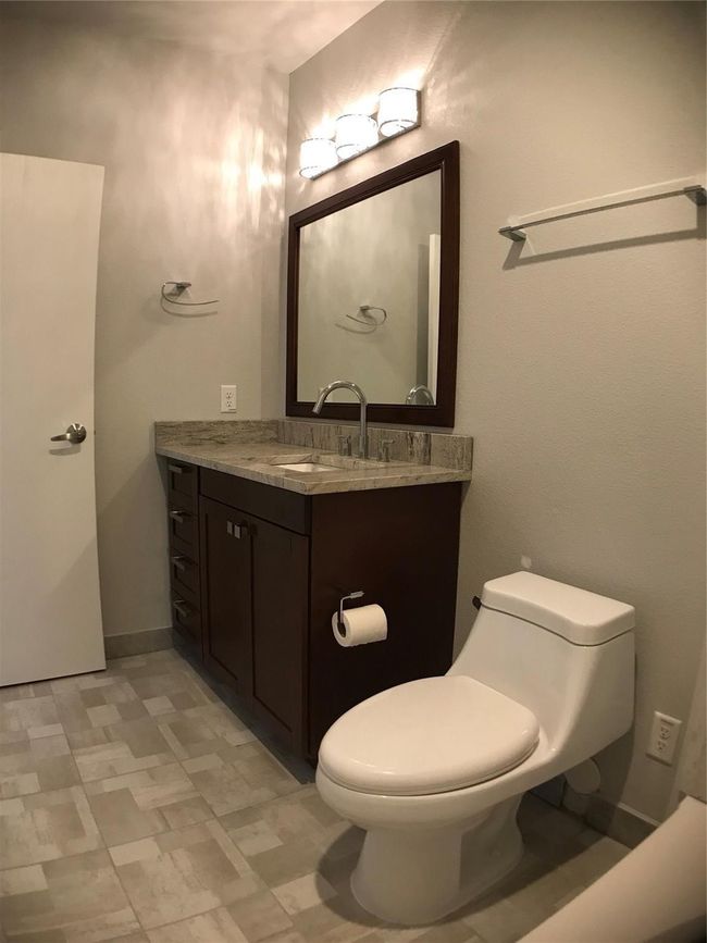 Half bath with tile patterned floors, toilet, and vanity | Image 15