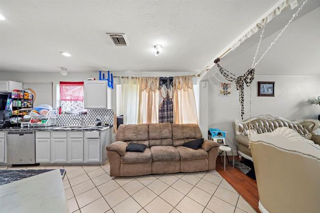 This eat-in kitchen features a smartly designed layout with a dedicated breakfast nook just off the main cooking area—perfect for morning coffee or casual family meals. Large windows allow natural light to brighten the space throughout the day. | Image 33