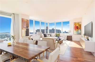 Dining room featuring expansive windows and light wood-type flooring | Image 3