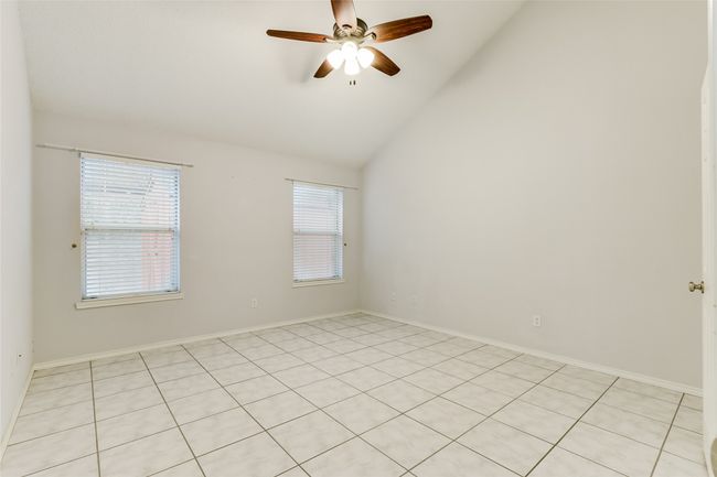 Unfurnished room featuring light tile patterned flooring, baseboards, a ceiling fan, and high vaulted ceiling | Image 17