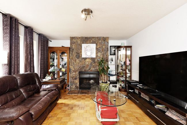 Living area featuring a stone fireplace | Image 8