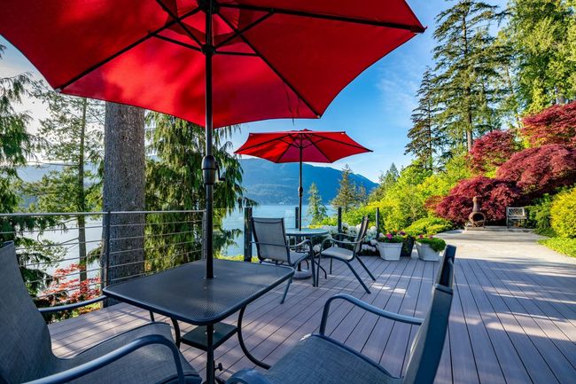Wooden terrace featuring outdoor dining area and a mountain view | Image 5