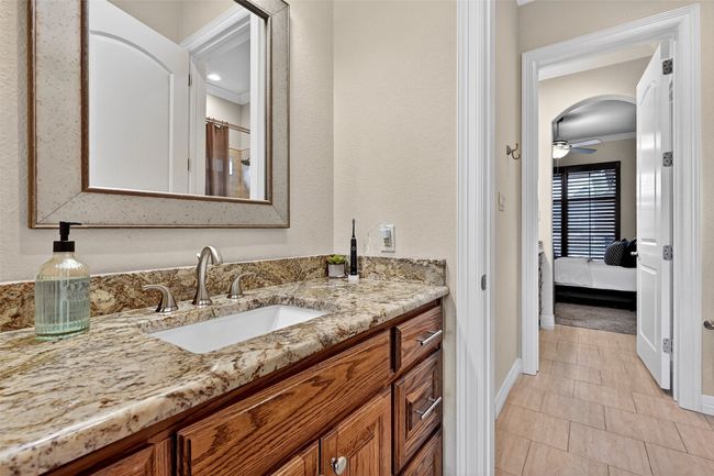 Bathroom featuring crown molding, vanity, tile patterned floors, ensuite bathroom, and ceiling fan | Image 22