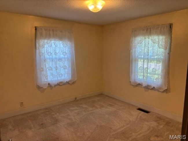 Unfurnished room featuring carpet, a textured ceiling, and baseboards | Image 28