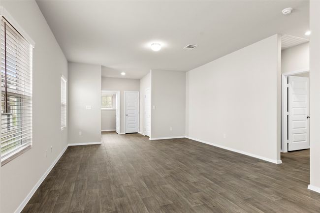 Spare room featuring baseboards, dark wood-style flooring, and visible vents | Image 4