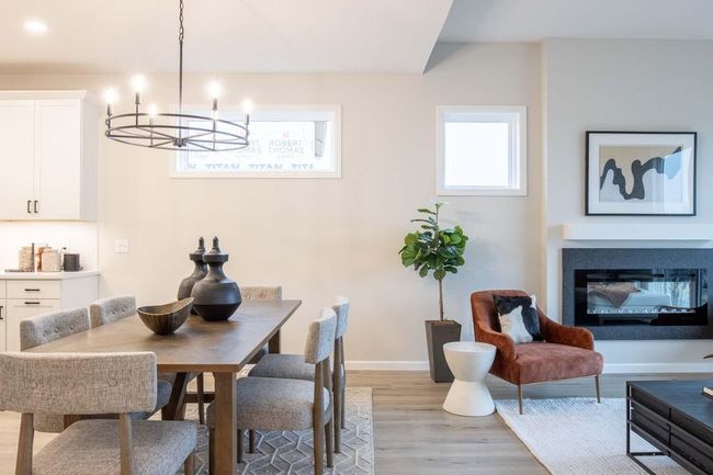 The open concept design seamlessly connects the family room, kitchen, and dining areas, perfect for both entertaining and daily living. Photos are from previously built home; options and features will vary. | Image 9
