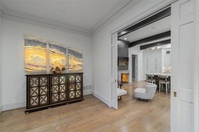 Foyer entrance featuring plenty of natural light, crown molding, and light hardwood / wood-style flooring | Image 2