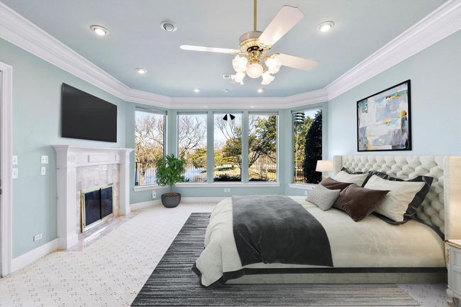 Primary bedroom with a view for days and a cozy fireplace. Virtually Staged. | Image 22