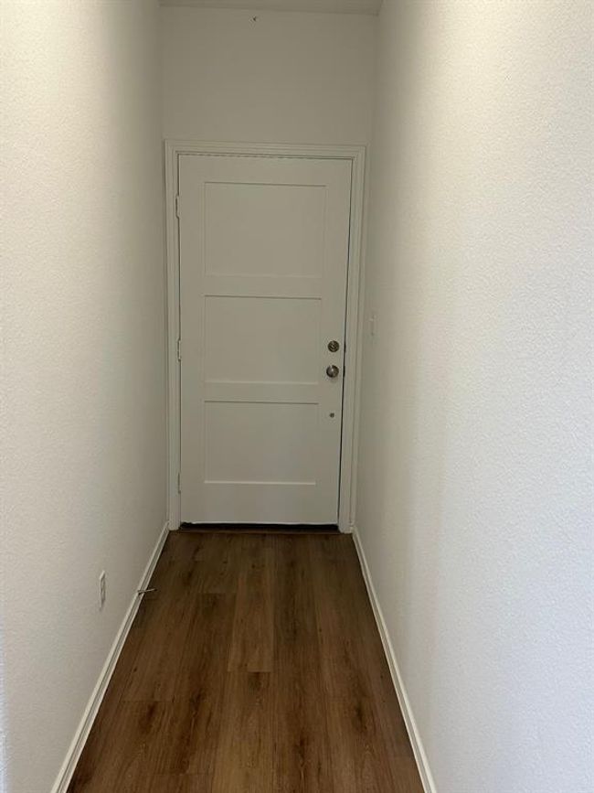 Hallway with dark wood-style floors and baseboards | Image 4