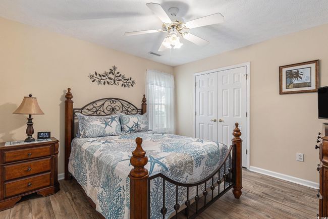 Bedroom featuring wood finished floors, a closet, baseboards, and ceiling fan | Image 26