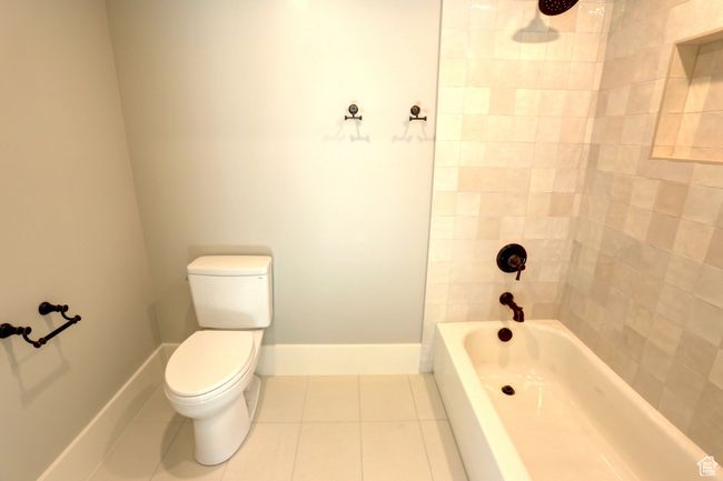 Full bath featuring tile patterned flooring and shower / tub combination | Image 38