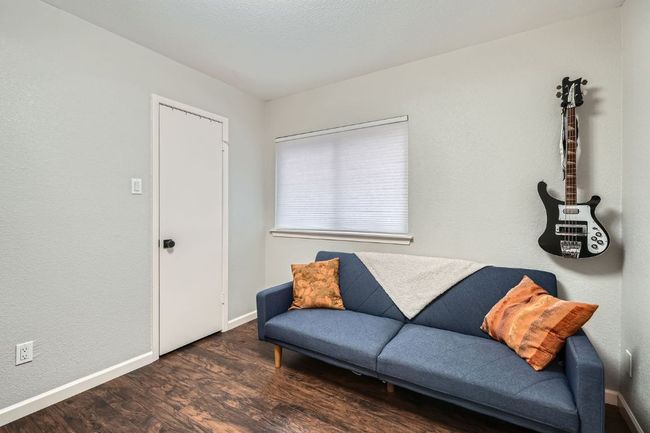 Sitting room with wood finished floors and baseboards | Image 21