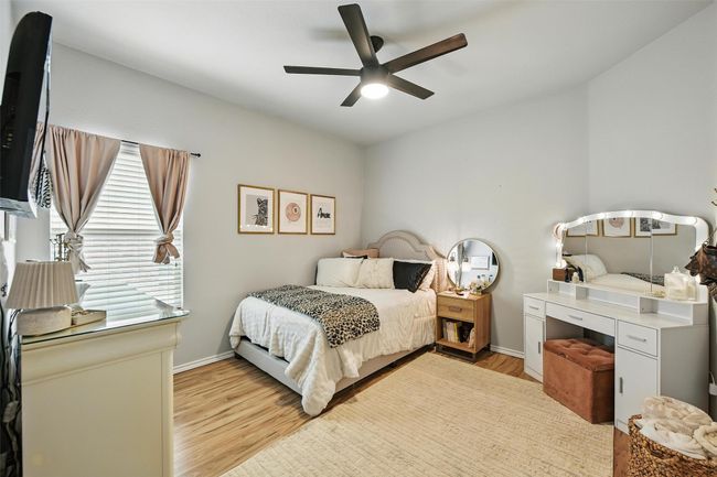 Bedroom featuring light wood-type flooring and a ceiling fan | Image 33
