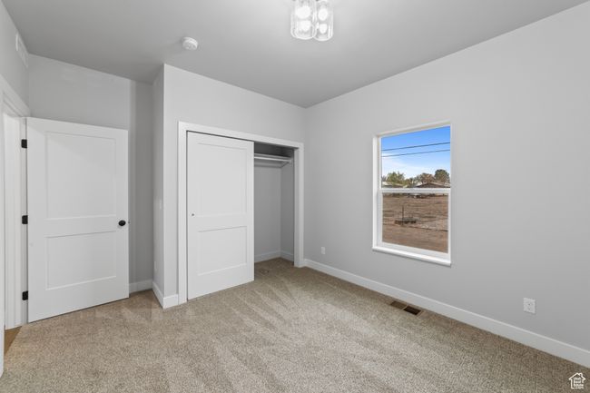 Unfurnished bedroom with baseboards, visible vents, a closet, and carpet floors | Image 29