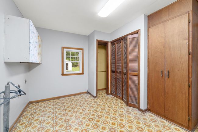 Laundry room featuring baseboards and cabinet space | Image 24