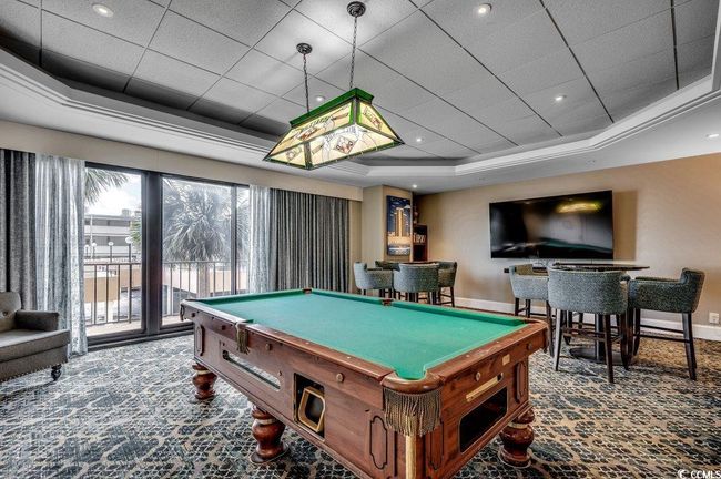Game room with pool table, carpet flooring, and a tray ceiling | Image 36