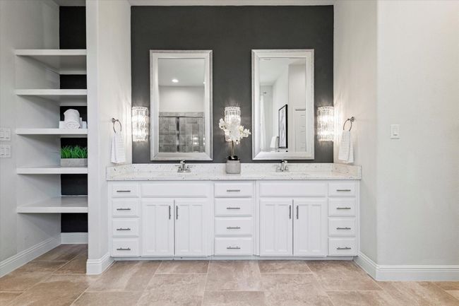 Full bathroom featuring double vanity, built in features, and tiled shower | Image 22