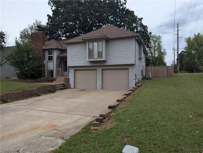 View of front of house featuring a garage and a front lawn | Image 2