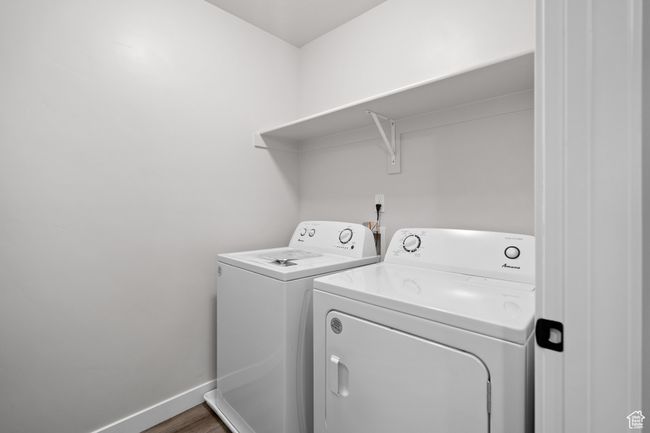 Washroom with separate washer and dryer and wood finished floors | Image 28