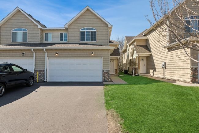 This townhome features beautiful low-maintenance vinyl and stone siding! | Image 8