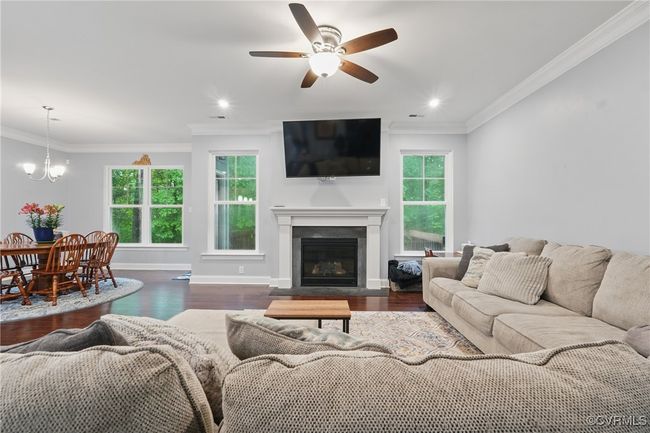 Spacious great room with gas fireplace, abundant natural light, and backyard views. | Image 4