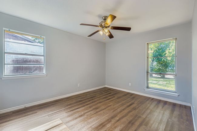 Spare room with wood finished floors and ceiling fan | Image 8