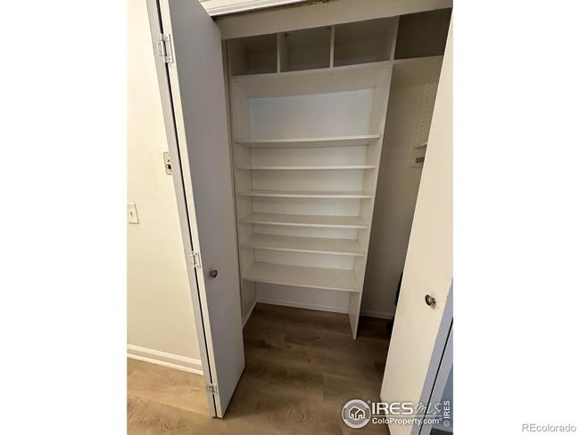 Built in closet shelves for storage in the living room. | Image 11