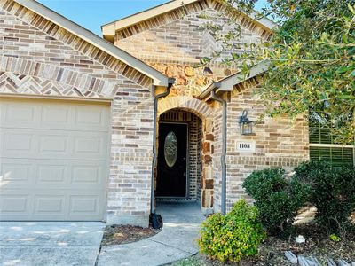 Doorway to property with a garage | Image 2