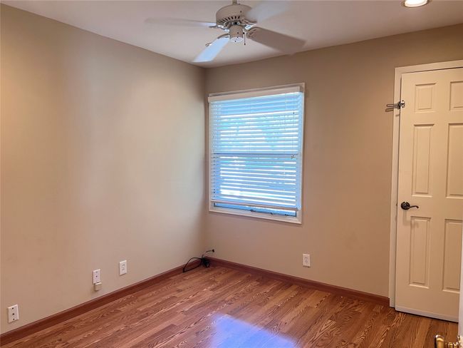 Spare room with wood finished floors, a ceiling fan, and recessed lighting | Image 9