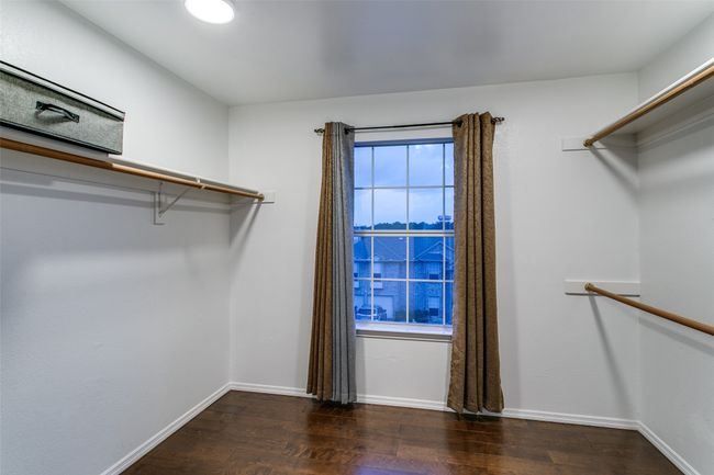 Spacious closet with wood finished floors | Image 17