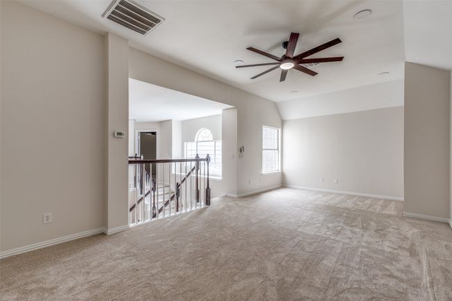 Unfurnished room featuring ceiling fan, carpet, lofted ceiling, and baseboards | Image 15