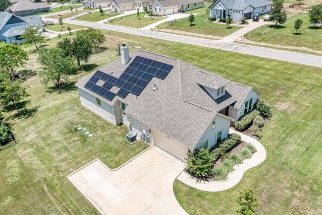 This aerial view clearly shows the 27 solar panels that will save the homeowner money. (Located near the side-entry 2.5 car garage) | Image 38