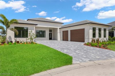 Prairie-style home featuring a front yard and a garage | Image 1