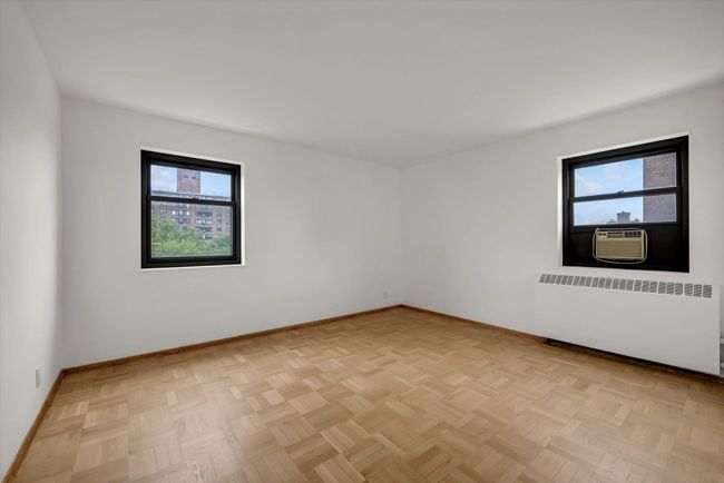 Spare room with radiator, healthy amount of natural light, and cooling unit | Image 7