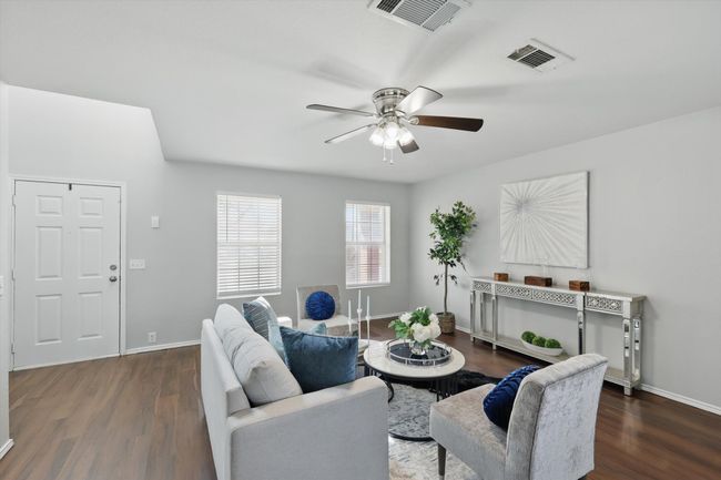 Living area with ceiling fan and wood finished floors | Image 7