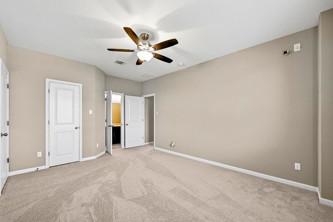 Unfurnished bedroom with light carpet and ceiling fan | Image 28
