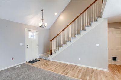 Entryway with hardwood / wood-style flooring and a notable chandelier | Image 3