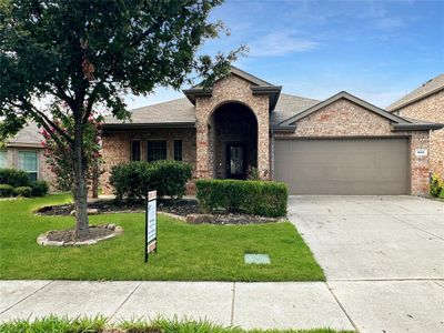 View of front of property with a garage and a front lawn | Image 1