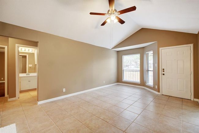 Another view of the living room, showing the hallway to the bedrooms | Image 9