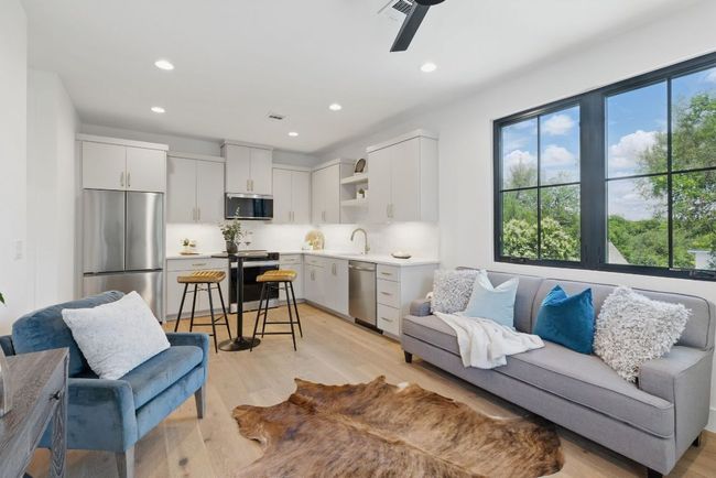 Living room with light wood-style flooring, recessed lighting, and a ceiling fan | Image 23