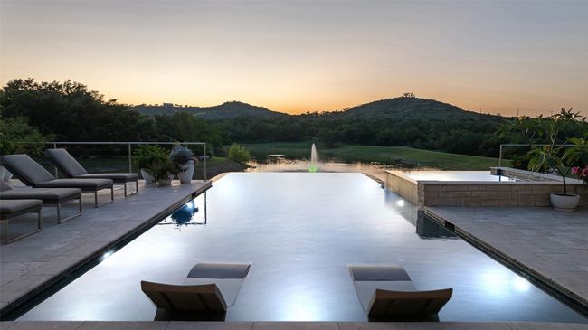 Pool at dusk with a mountain view, an infinity pool, and a patio area | Image 10