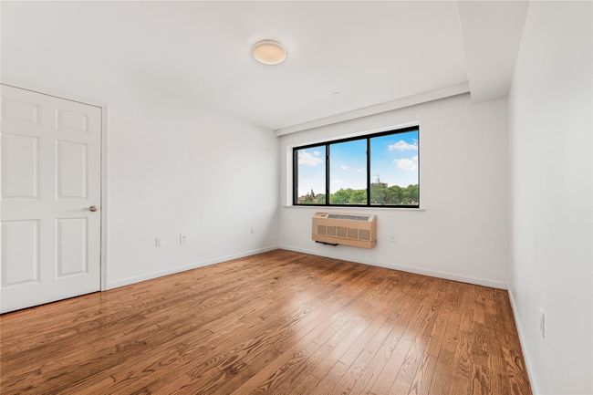 Spare room with hardwood / wood-style flooring and a wall unit AC | Image 21