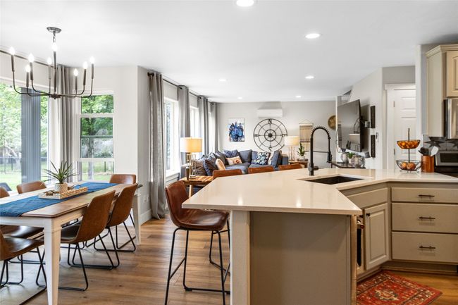 Kitchen with open floor plan, light countertops, a chandelier, light wood-type flooring, and recessed lighting | Image 36